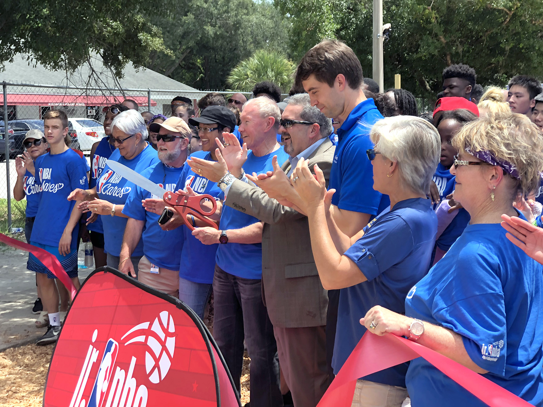 Cutting ribbon at new NBA Cares park.