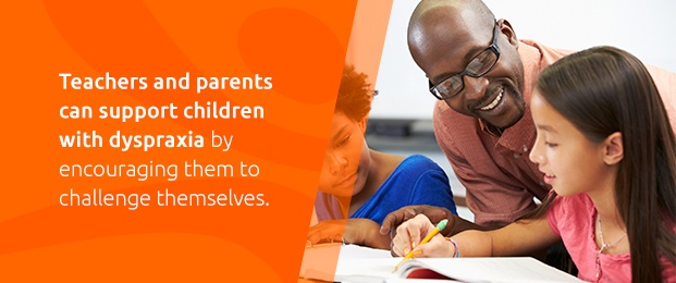 Teacher Supporting Child With Dyspraxia