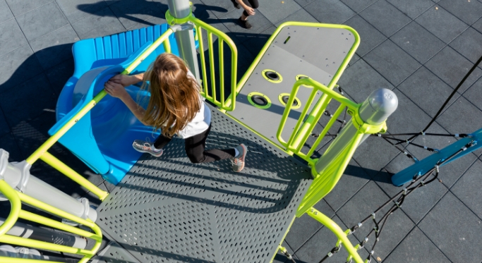 Girl getting ready to go down a playground slide