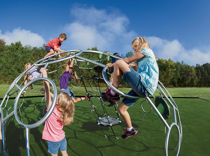 Children climbing on a modern jungle gym structure in a grassy park playground, showcasing playground equipment for city parks.
