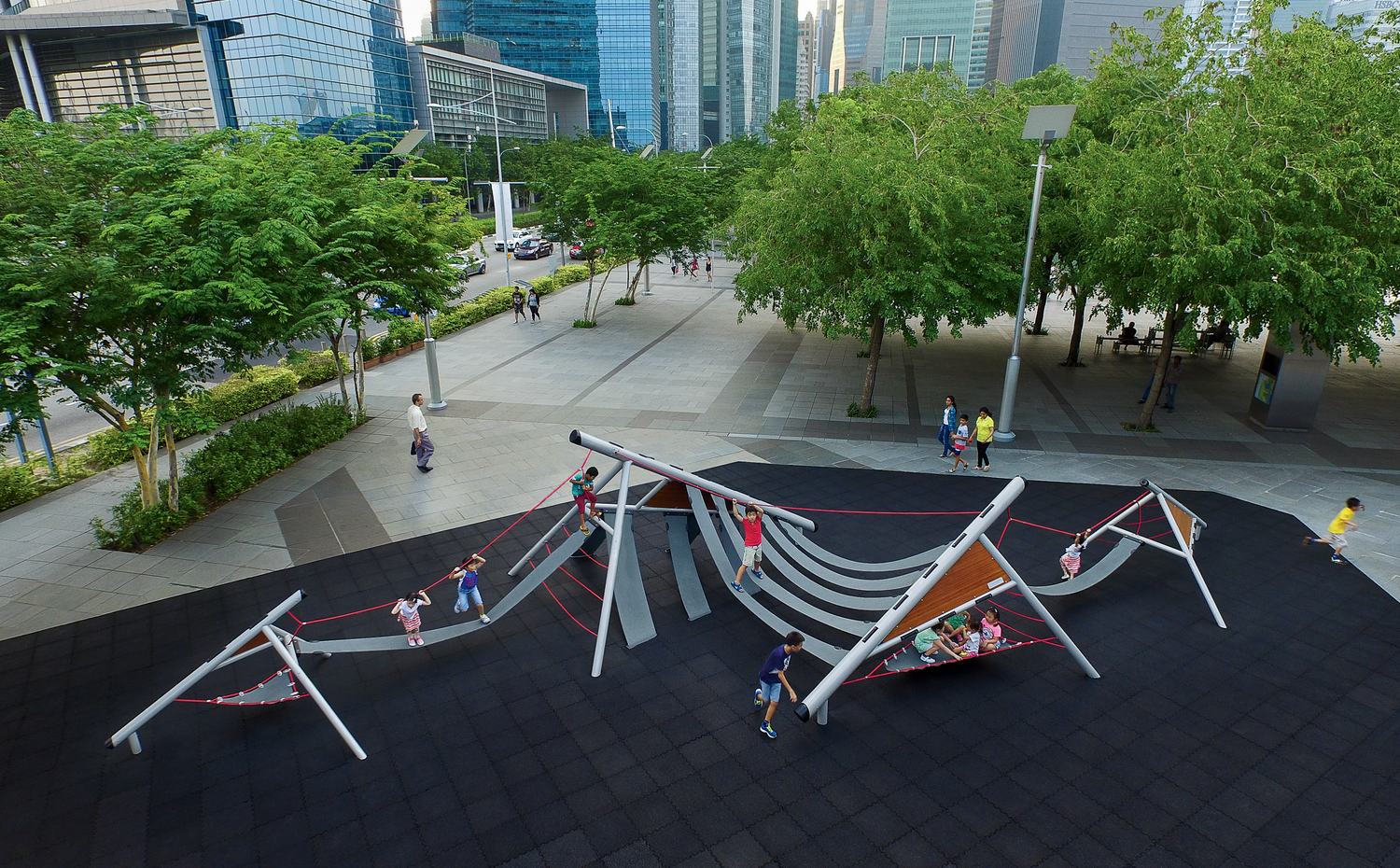 Kids playing on Playform 7 at a park in an urban area