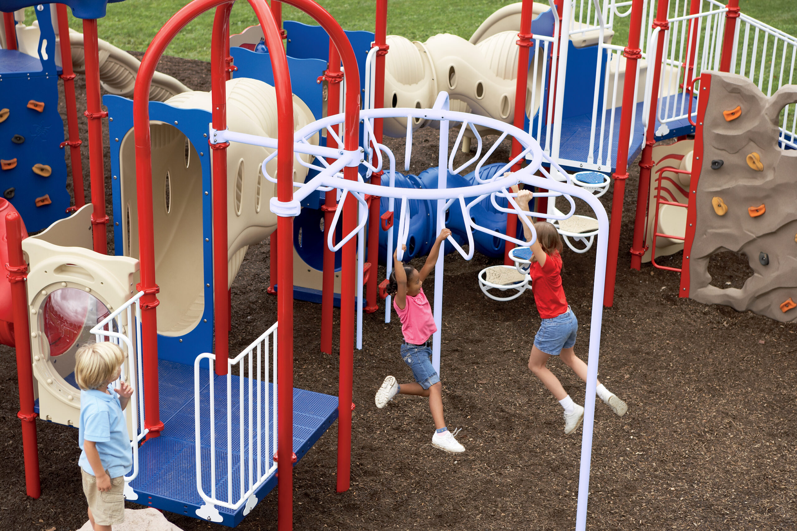 Children playing on an overhead ladder and building their upper body strength