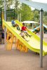 Kids sliding down a Mighty Descent slide
