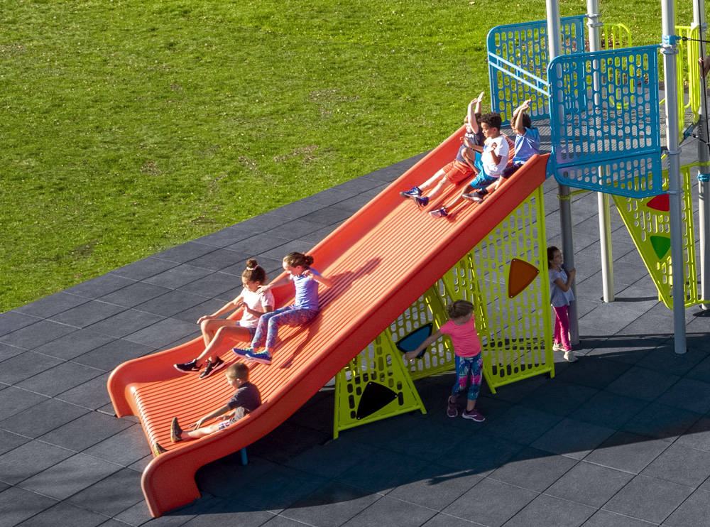 Kids sliding down a Mighty Descent slide